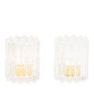 A pair of Ripple Glass Tealight/Votive Holder Pair, clear glass with lit tealights against a white background.