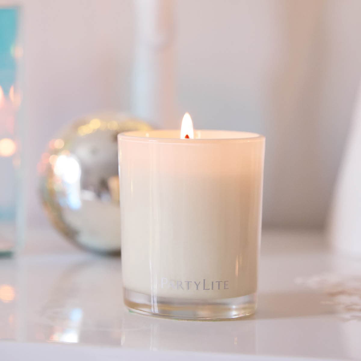 Sun-Kissed Linen Escential Jar candle, a light cream jar lit against a light background.