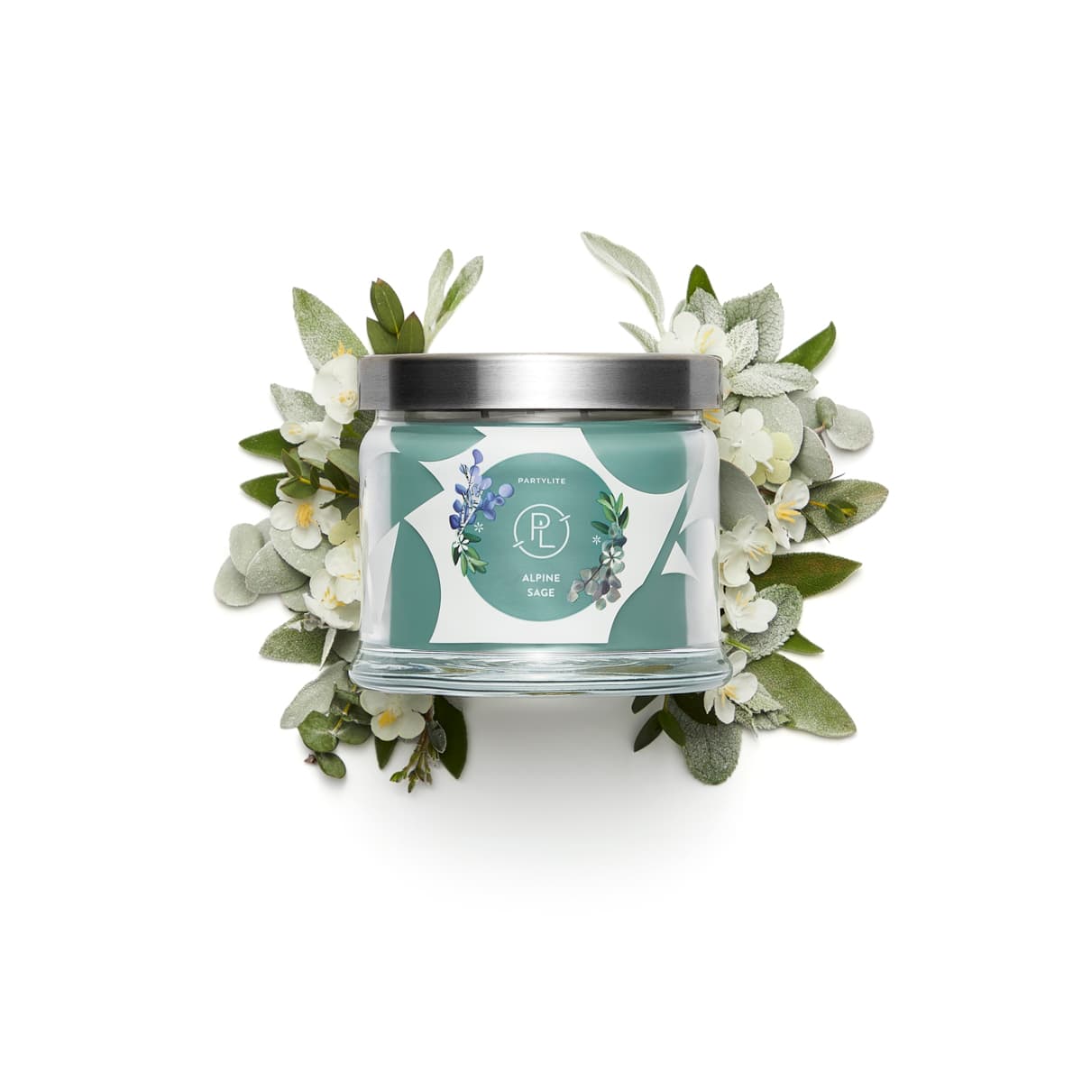 Alpine Sage 3-Wick Jar Candle surrounded by white flowers against a white surface.