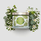 Farm Fresh Herbs 3-Wick Jar Candle shown with leaves and flowers against a white background.