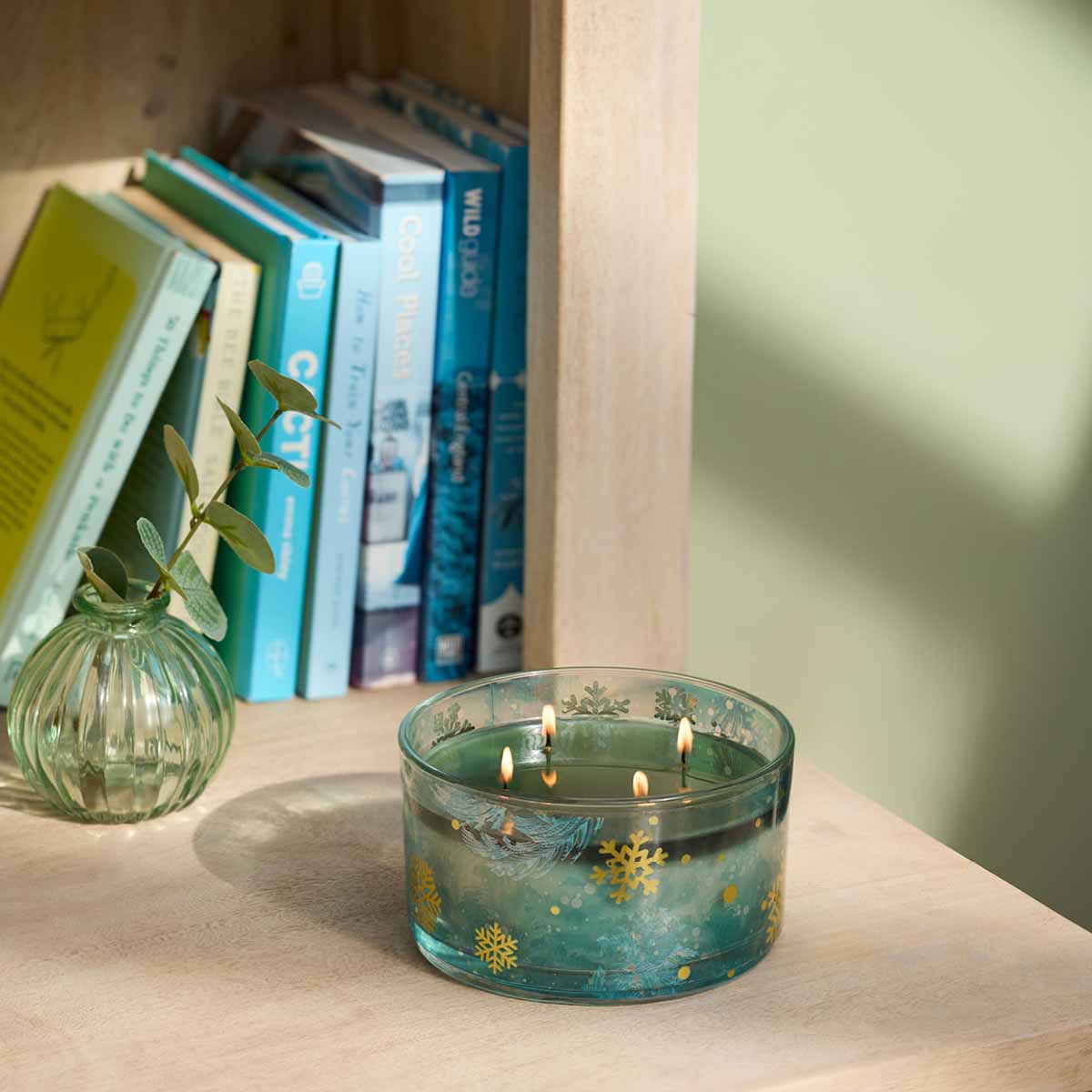 Winter Morning Specialty Jar Candle on a wood surface with books in the background.