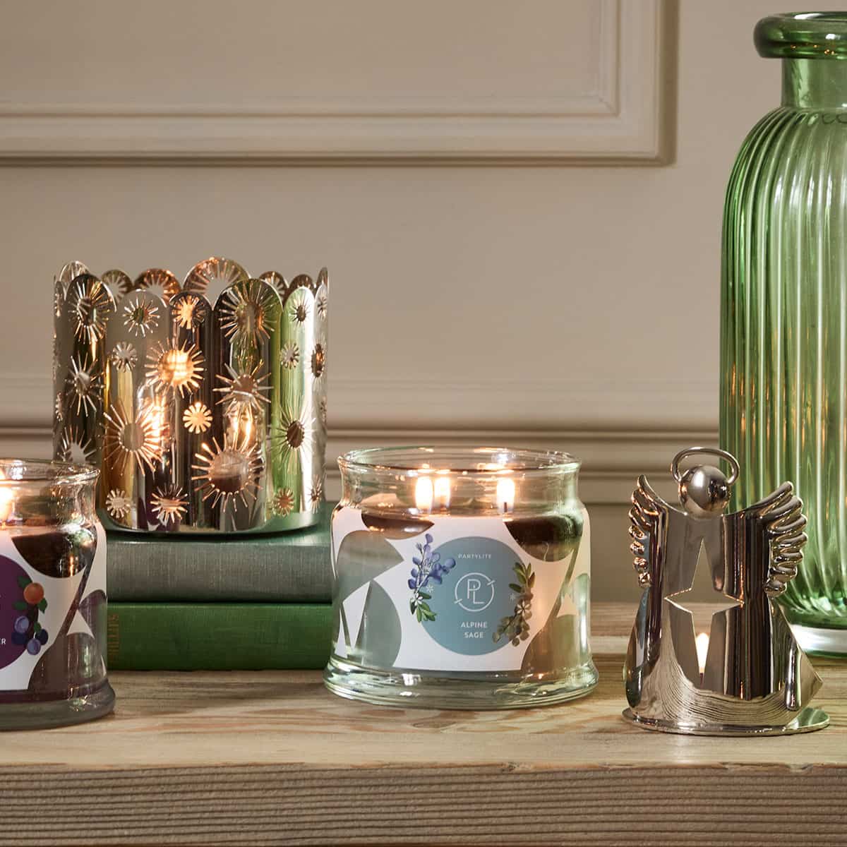 Alpine Sage 3-Wick Jar Candle on a wooden surface with an Angel tealight holder beside it.