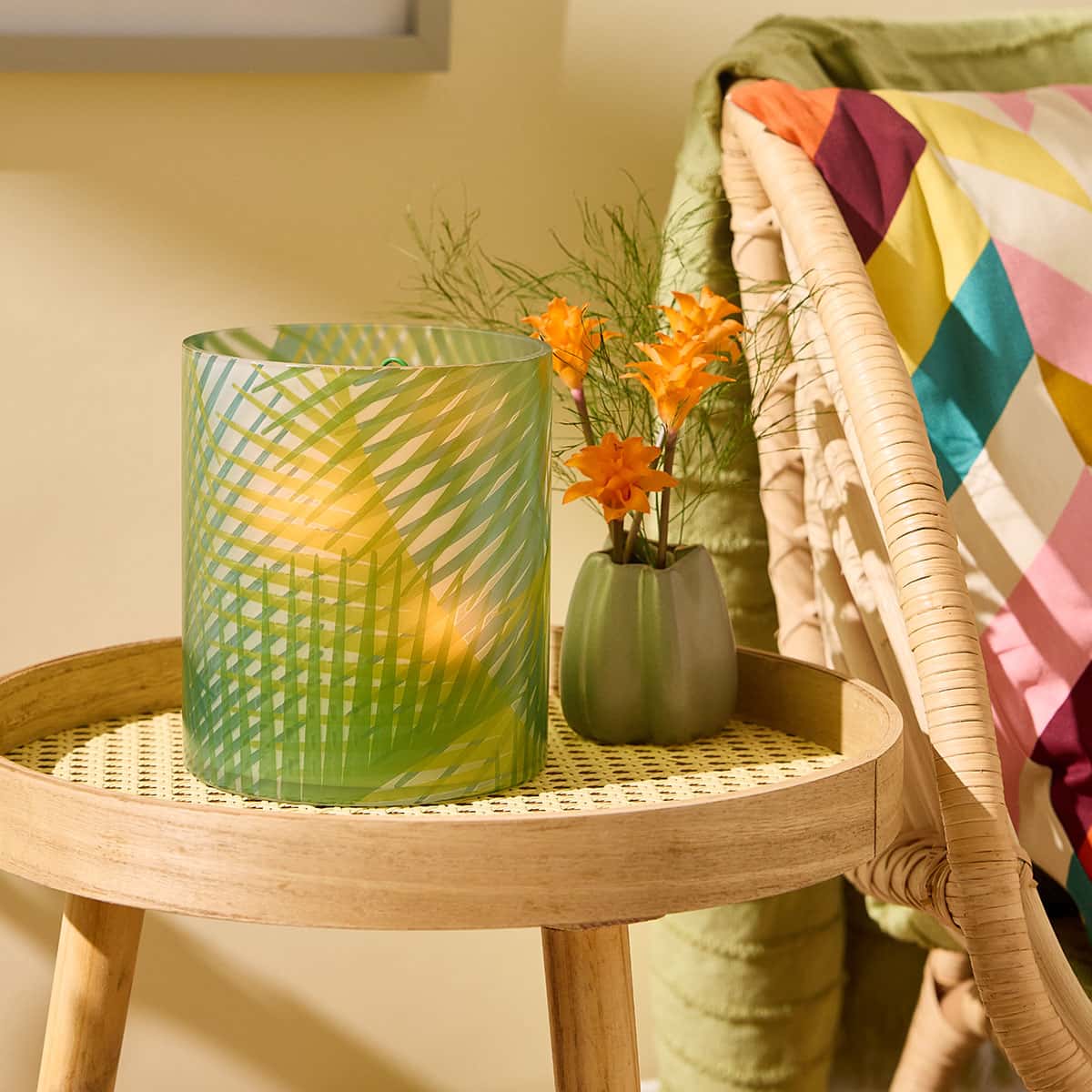 Tropical Palm Hurricane on a small wooden table next to a plant and an edge of a wicker sofa with a light background