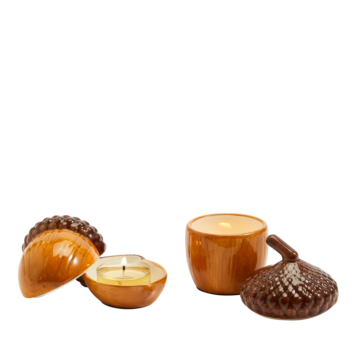 Acorn Tealight Holder Pair with lit tealights against a white background.