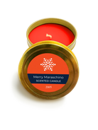 Merry Maraschino scented candle in a gold tin with an orange label on a white background
