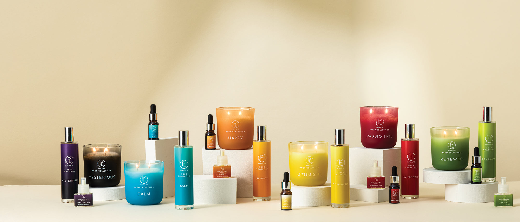 Mood collection jar candles, room sprays, and fragranced oils on a neutral background.