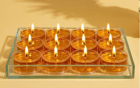 12 lit tealights in a 4 x 3 grid within a glass rectangular tray