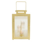 Gold lantern with a clear glass panel on a white background