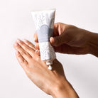 Iced Snowberries Hand Cream shown being used on hands with a white background