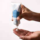 Sea Salt and Sage hand cream being used on a person hand