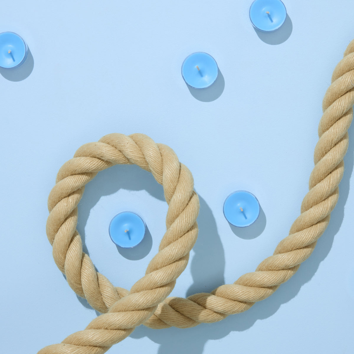 Beige rope with a light blue background with scattered blue tealights.